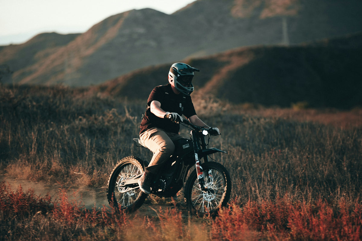Rider on an electric dirt bike in the hills
